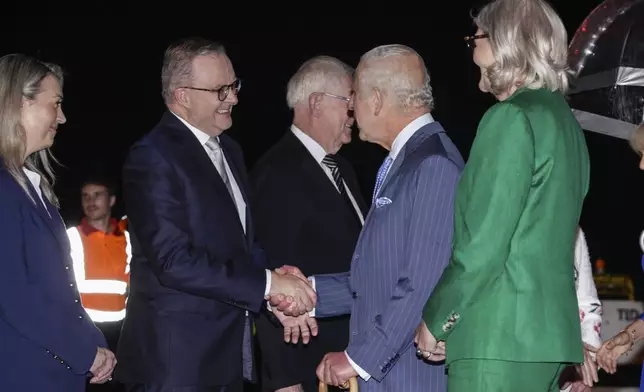 Britain's King Charles shakes hands with Australian Prime Minister Anthony Albanese on his arrival into Sydney for the start of a five-day tour to Australia, Friday, Oct. 18, 2024. (Brook Mitchell/Pool Photo via AP)