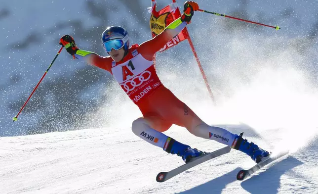 Switzerland's Marco Odermatt speeds down the course during an alpine ski, men's World Cup giant slalom, in Soelden, Austria, Sunday, Oct. 27, 2024. (AP Photo/Alessandro Trovati)