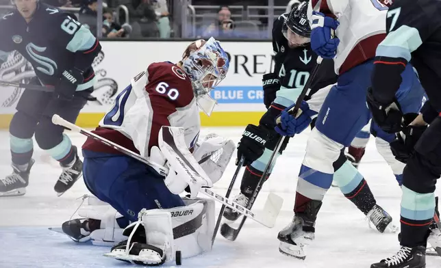 Colorado Avalanche goaltender Justus Annunen blocks the puck shot by Seattle Kraken center Matty Beniers (10) during the third period of an NHL hockey game, Tuesday, Oct. 22, 2024, in Seattle. The Avalanche won 3-2. (AP Photo/John Froschauer)