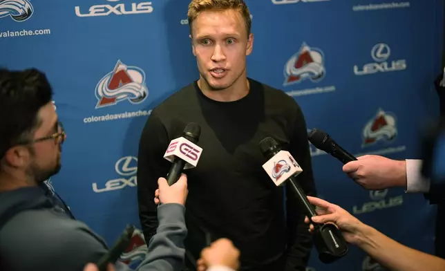 Colorado Avalanche right wing Logan O'Connor responds to questions during a news conference to announce that he signed a six-year contract extension with the hockey club Monday, Sept. 23, 2024, in Denver. (AP Photo/David Zalubowski)