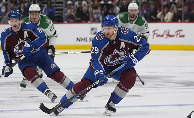 FILE - Colorado Avalanche center Nathan MacKinnon collects the puck in the third period of Game 6 of an NHL hockey playoff series Friday, May 17, 2024, in Denver. (AP Photo/David Zalubowski)