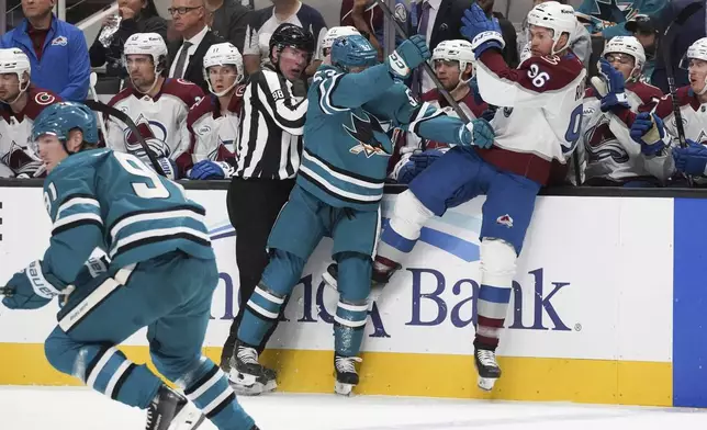 San Jose Sharks center Ty Dellandrea, left, checks Colorado Avalanche right wing Mikko Rantanen (96) during the first period of an NHL hockey game in San Jose, Calif., Sunday, Oct. 20, 2024. (AP Photo/Minh Connors)