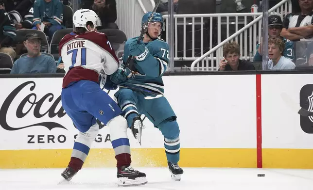 Colorado Avalanche center Calum Ritchie (71), left, checks San Jose Sharks left wing William Eklund during the first period of an NHL hockey game in San Jose, Calif., Sunday, Oct. 20, 2024. (AP Photo/Minh Connors)