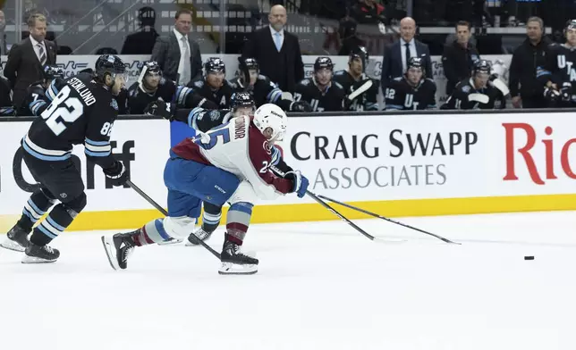 Colorado Avalanche forward Logan O'Connor (25) goes for possession of the puck against Utah Hockey Club forwards Kailer Yamamoto (56) and Kevin Stenlund (82) during the first period of an NHL hockey game Thursday, Oct. 24, 2024, in Salt Lake City. (AP Photo/Melissa Majchrzak)