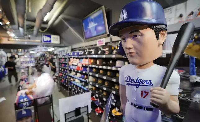 Goods related to Shohei Ohtani of the Los Angeles Dodgers are displayed at a sporting goods store, "SELECTION," in Shinjuku district Wednesday, Oct. 23, 2024 in Tokyo. (AP Photo/Eugene Hoshiko)