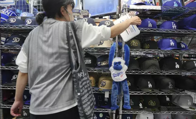 A customer shops around for goods related to Shohei Ohtani of the Los Angeles Dodgers at a sporting goods store, "SELECTION," in Shinjuku district Wednesday, Oct. 23, 2024 in Tokyo. (AP Photo/Eugene Hoshiko)