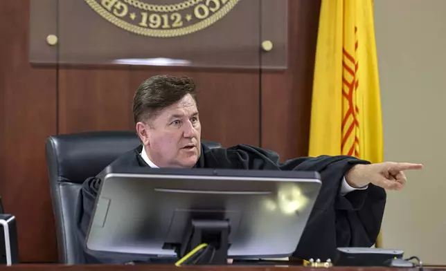 Judge T. Glenn Ellington speaks to Hannah Gutierrez-Reed, the weapons supervisor on the set of the Western film “Rust," and her lawyer Jason Bowles during a plea hearing at the First Judicial District Courthouse in Santa Fe, N.M., Monday, Oct. 7, 2024. (Gabriela Campos/Santa Fe New Mexican via AP, Pool)