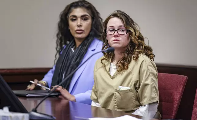 Hannah Gutierrez-Reed, the weapons supervisor on the set of the Western film “Rust," right, sits beside paralegal Carmella Sisneros at the start of her plea hearing at the First Judicial District Courthouse in Santa Fe, N.M., Monday, Oct. 7, 2024. (Gabriela Campos/Santa Fe New Mexican via AP, Pool)