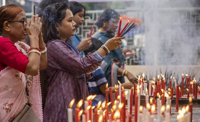 Hindu devotees offer prayers at the Dhakeshwari National Temple during the Durgapuja festival in Dhaka, Bangladesh, on Oct. 10, 2024. (AP Photo/Rajib Dhar)