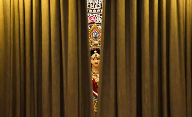 An idol of Hindu goddess Durga is seen as curtains of a tableau opens at Dhakeshwari National Temple during the Durgapuja festival in Dhaka, Bangladesh, on Oct. 10, 2024. (AP Photo/Rajib Dhar)