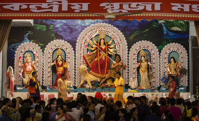 A tableau depicting the slaying of demon Mahishasura by the Hindu goddess Durga, center, is installed with other gods at Dhakeshwari National Temple during the Durgapuja festival in Dhaka, Bangladesh, on Oct. 10, 2024. (AP Photo/Rajib Dhar)