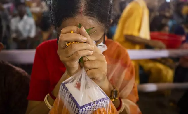 A woman offers prayer at the Dhakeshwari National Temple during the Durgapuja festival in Dhaka, Bangladesh, on Oct. 10, 2024. (AP Photo/Rajib Dhar)