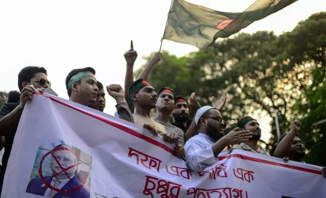 Protesters gather to demand the resignation of President Mohammed Shahabuddin after his comments that he had no documents proving that former Prime Minister Sheikh Hasina had resigned before fleeing the country, in Dhaka, Bangladesh, Tuesday, Oct. 22, 2024. (AP Photo/Mahmud Hossain Opu)