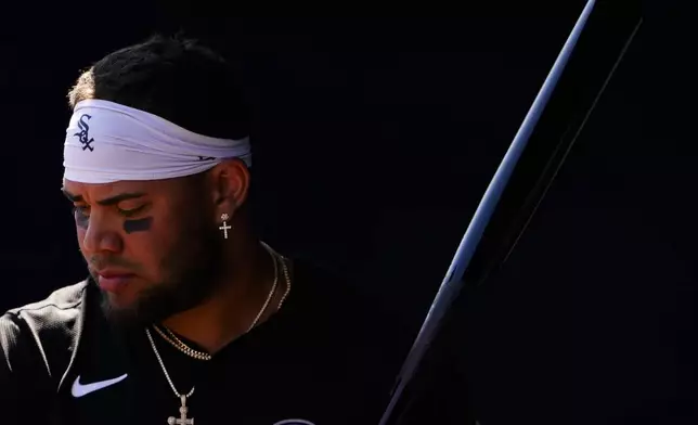 FILE - Chicago White Sox's Yoan Moncada holds a bat in the dugout before a spring training baseball game against the San Diego Padres, March 9, 2024, in Peoria, Ariz. (AP Photo/Lindsey Wasson, File)