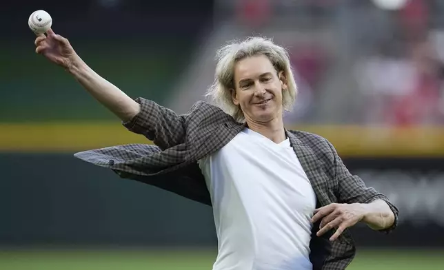 FILE - Former Cincinnati Reds player Bronson Arroyo throws out a ceremonial first pitch before a baseball game between the Reds and the Milwaukee Brewers, July 15, 2023, in Cincinnati. (AP Photo/Darron Cummings, File)