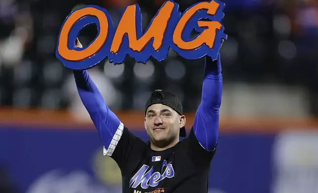 FILE - New York Mets second baseman Jose Iglesias celebrates on the field after the Mets beat the Philadelphia Phillies in Game 4 of the National League baseball playoff series, Oct. 9, 2024, in New York. (AP Photo/Adam Hunger, File)