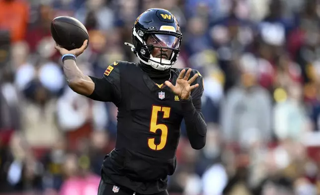 Washington Commanders quarterback Jayden Daniels passes against the Chicago Bears in the first half of an NFL football game Sunday, Oct. 27, 2024, in Landover, Md. (AP Photo/Nick Wass)