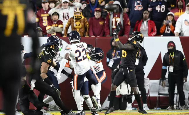 Washington Commanders wide receiver Noah Brown (85) catches a 52-yard touchdown pass in the end zone as time expires to give the Commanders an 18-15 win over the Chicago Bears in an NFL football game Sunday, Oct. 27, 2024, in Landover, Md. (AP Photo/Nick Wass)