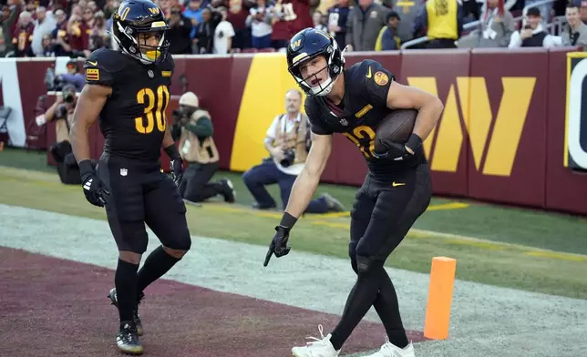 Washington Commanders wide receiver Luke McCaffrey (12) argues unsuccessfully after he caught a pass but was ruled out of bounds in the first half of an NFL football game against the Chicago Bears Sunday, Oct. 27, 2024, in Landover, Md. (AP Photo/Stephanie Scarbrough)