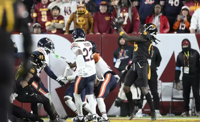 Washington Commanders wide receiver Noah Brown (85) catches a 52-yard touchdown pass in the end zone as time expires to give the Commanders an 18-15 win over the Chicago Bears in an NFL football game Sunday, Oct. 27, 2024, in Landover, Md. (AP Photo/Nick Wass)