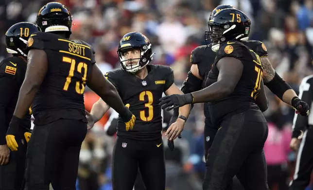 Washington Commanders place kicker Austin Seibert (3) is congratulated after kicking a 28-yard field goal against the Chicago Bears in the first half of an NFL football game Sunday, Oct. 27, 2024, in Landover, Md. (AP Photo/Nick Wass)