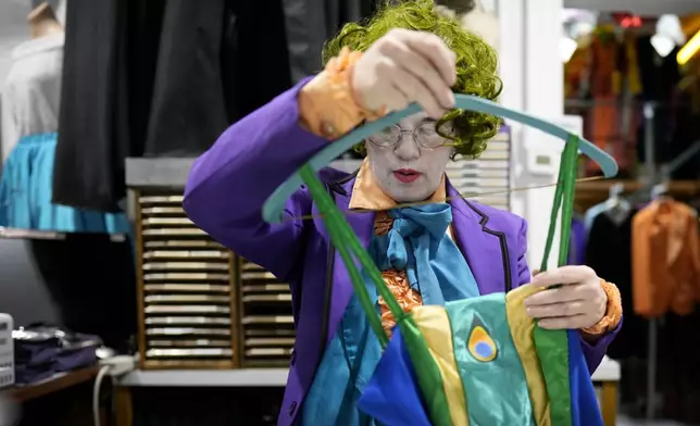 Michelle Nielsen prepares a costume for display at The Theatrical Shop, Tuesday, Oct. 29, 2024, in West Des Moines, Iowa. (AP Photo/Charlie Neibergall)