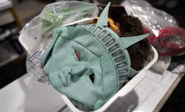 Masks sit in a basket at The Theatrical Shop, Tuesday, Oct. 29, 2024, in West Des Moines, Iowa. (AP Photo/Charlie Neibergall)