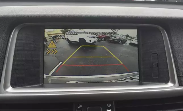 This photo provided by Edmunds shows a rear cross-traffic warning alert in a Kia Optima. These systems typically indicate the direction in which vehicles are approaching. (Courtesy of Edmunds via AP)