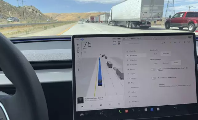This photo provided by Edmunds shows an adaptive cruise system operating on a Tesla Model 3. Adaptive cruise holds a constant speed and can also slow or accelerate the vehicle. (Courtesy of Edmunds via AP)