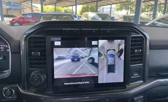 This photo provided by Edmunds shows a surround-view camera display in a Ford F-150. Multiple camera views are stitched together to create a virtual top-down view that makes parking much easier. (Courtesy of Edmunds via AP)