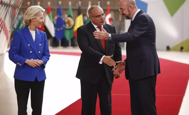 European Council President Charles Michel, right, and European Commission President Ursula von der Leyen, left, welcome Bahrain's Prime Minister Crown Prince Salman bin Hamad Al Khalifa during an EU-Gulf Cooperation Council meeting at the European Council building in Brussels, Belgium, Wednesday, Oct. 16, 2024. (Johanna Geron, Pool Photo via AP)