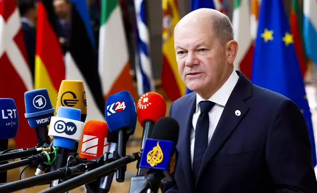 Germany's Chancellor Olaf Scholz talks to journalists as he arrives to an EU summit in Brussels, Thursday, Oct. 17, 2024. (AP Photo/Geert Vanden Wijngaert)