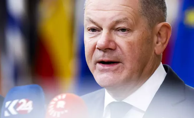 Germany's Chancellor Olaf Scholz talks to journalists as he arrives to an EU summit in Brussels, Thursday, Oct. 17, 2024. (AP Photo/Geert Vanden Wijngaert)