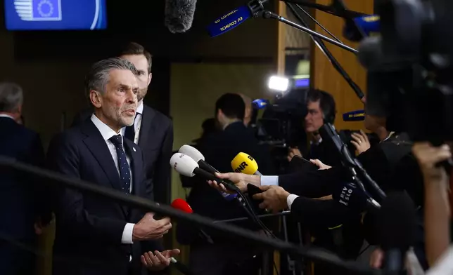 Netherland's Prime Minister Dick Schoof talks to journalists as he arrives to an EU summit in Brussels, Thursday, Oct. 17, 2024. (AP Photo/Geert Vanden Wijngaert)