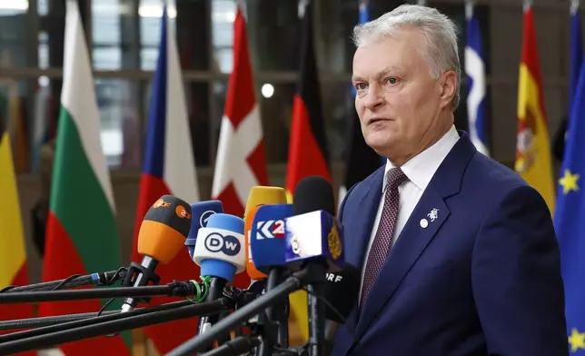 Lithuania's President Gitanas Nauseda talks to journalists as he arrives to an EU summit in Brussels, Thursday, Oct. 17, 2024. (AP Photo/Geert Vanden Wijngaert)