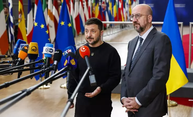 Ukraine's President Volodymyr Zelenskyy, left, and European Council President Charles Michel talk to journalists as they arrive to an EU summit in Brussels, Thursday, Oct. 17, 2024. (AP Photo/Geert Vanden Wijngaert)