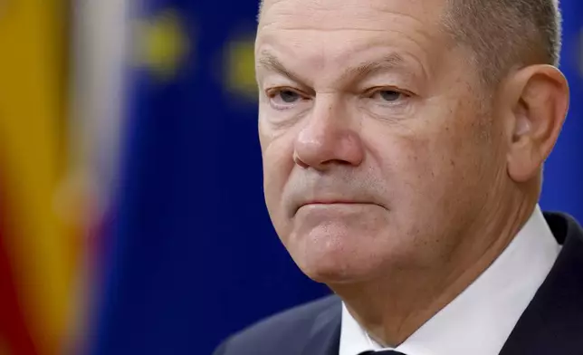 Germany's Chancellor Olaf Scholz talks to journalists as he arrives to an EU summit in Brussels, Thursday, Oct. 17, 2024. (AP Photo/Geert Vanden Wijngaert)