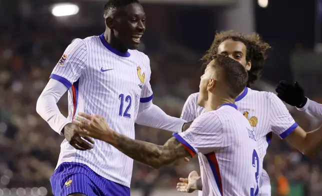 France's Randal Kolo Muani, left, celebrates after scoring his sides second goal during the UEFA Nations League, group A2 soccer match between Belgium and France at the King Baudouin stadium in Brussels, Belgium, Monday, Oct. 14, 2024. (AP Photo/Geert Vanden Wijngaert)