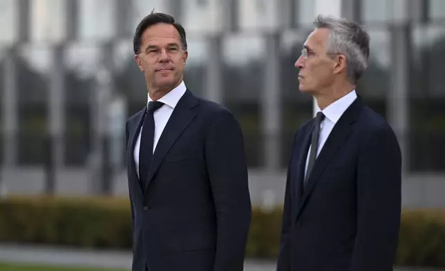 The incoming NATO Secretary General Mark Rutte, left, and NATO Secretary General Jens Stoltenberg stand during a wreath laying ceremony at NATO headquarters in Brussels, Belgium, Tuesday, Oct. 1, 2024. (AP Photo/Harry Nakos)