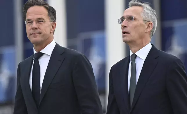 NATO Secretary General Jens Stoltenberg, right, and the incoming NATO Secretary General Mark Rutte arrive for a transition ceremony at NATO headquarters in Brussels, Tuesday, Oct. 1, 2024. (AP Photo/Harry Nakos)