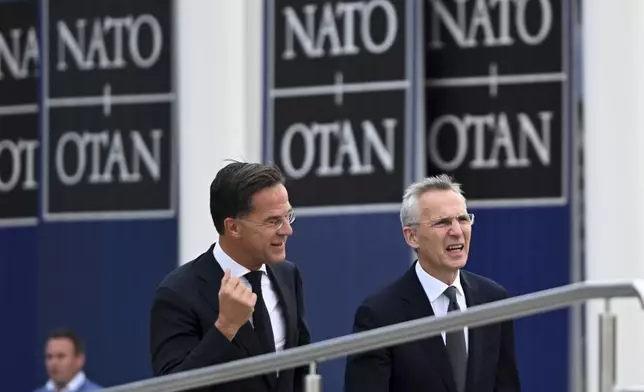 NATO Secretary General Jens Stoltenberg, right, with incoming NATO Secretary General Mark Rutte arrives for a transition ceremony at NATO headquarters in Brussels, Tuesday, Oct. 1, 2024. (AP Photo/Harry Nakos)