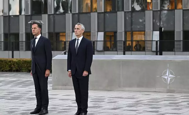 NATO Secretary General Jens Stoltenberg, right, and the incoming NATO Secretary General Mark Rutte stand during a wreath laying ceremony at NATO headquarters in Brussels, Belgium, Tuesday, Oct. 1, 2024. (AP Photo/Harry Nakos)