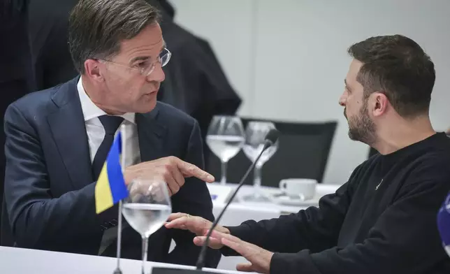 NATO Secretary General Mark Rutte, left, speaks with Ukraine's President Volodymyr Zelenskyy during the NATO-Ukraine Council working dinner at NATO Headquarters in Brussels, Thursday, Oct. 17, 2024. (Olivier Matthys, Pool Photo via AP)