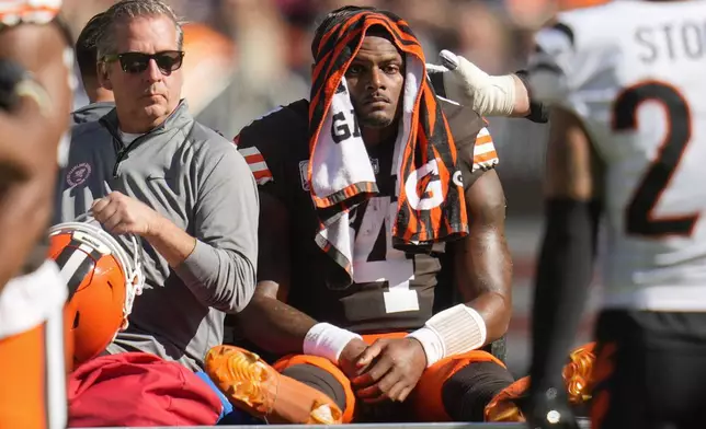 Cleveland Browns quarterback Deshaun Watson (4) is carted off the field after being injured in the first half of an NFL football game against the Cincinnati Bengals, Sunday, Oct. 20, 2024, in Cleveland. (AP Photo/Sue Ogrocki)