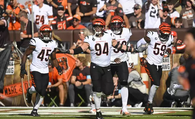 Cincinnati Bengals defensive end Sam Hubbard (94) celebrates his interception in the second half of an NFL football game against the Cleveland Browns, Sunday, Oct. 20, 2024, in Cleveland. (AP Photo/David Richard)