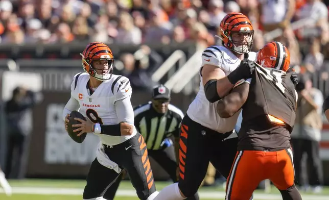 Cincinnati Bengals quarterback Joe Burrow (9) drops back to pass in the first half of an NFL football game against the Cleveland Browns, Sunday, Oct. 20, 2024, in Cleveland. (AP Photo/Sue Ogrocki)