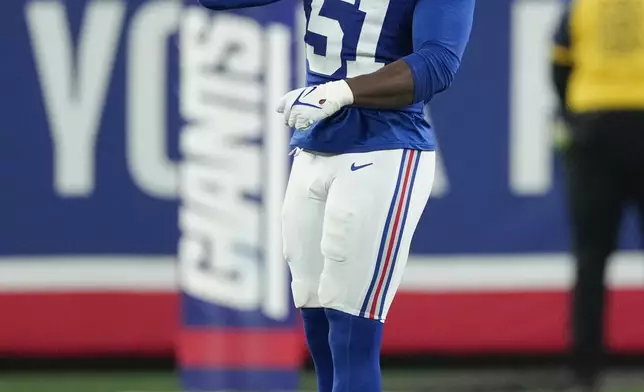 New York Giants linebacker Azeez Ojulari (51) celebrates after sacking Cincinnati Bengals quarterback Joe Burrow during the first half of an NFL football game, Sunday, Oct. 13, 2024, in East Rutherford, N.J. (AP Photo/Seth Wenig)