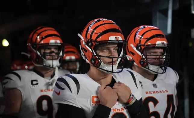 Cincinnati Bengals quarterback Joe Burrow, center, looks out from the tunnel before taking the field with teammates for an NFL football game against the New York Giants, Sunday, Oct. 13, 2024, in East Rutherford, N.J. (AP Photo/Seth Wenig)