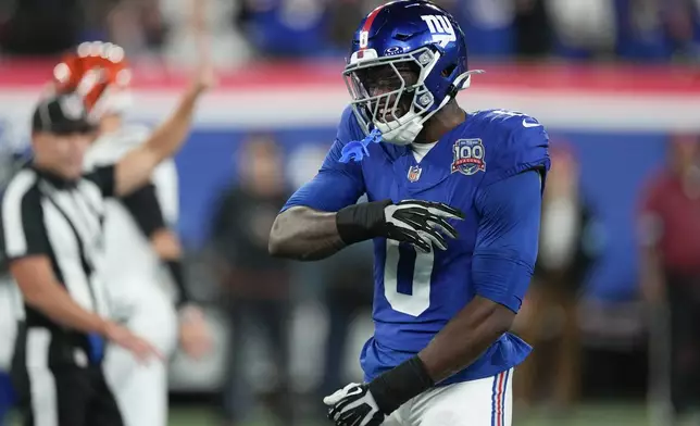 New York Giants linebacker Brian Burns celebrates a tackle during the first half of an NFL football game against the Cincinnati Bengals, Sunday, Oct. 13, 2024, in East Rutherford, N.J. (AP Photo/Seth Wenig)