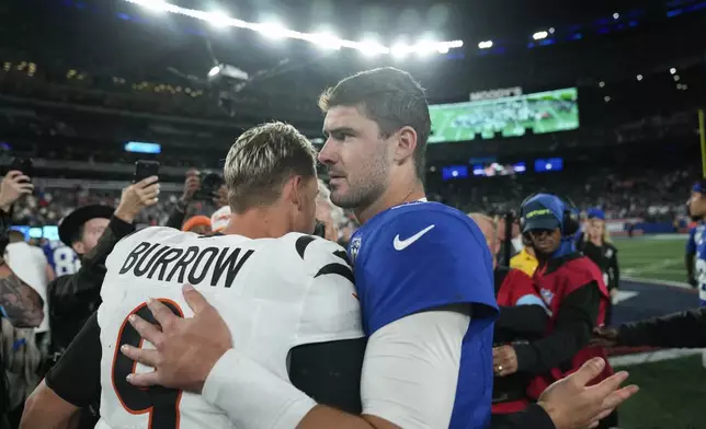 Cincinnati Bengals quarterback Joe Burrow (9) and New York Giants quarterback Daniel Jones, right, greet each other on the field after an NFL football game, Sunday, Oct. 13, 2024, in East Rutherford, N.J. The Bengals won 17-7. (AP Photo/Seth Wenig)